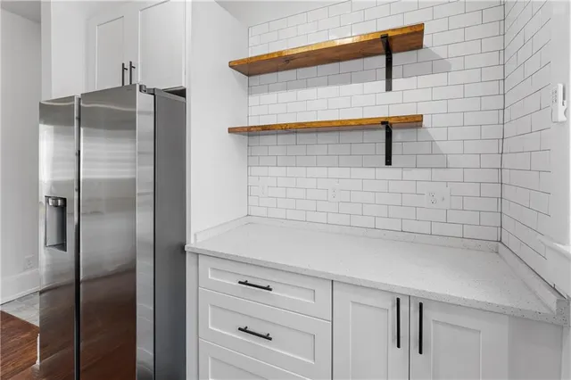 a bathroom with a shower and a sink