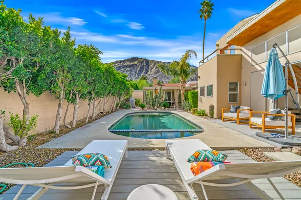 a swimming pool with outdoor seating