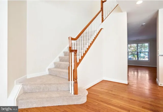 a view of entryway and hall with wooden floor
