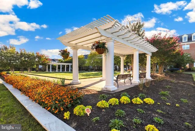 a view of a house with swimming pool and sitting area