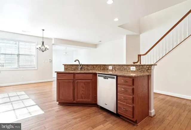 a spacious bathroom with a granite countertop sink and a mirror