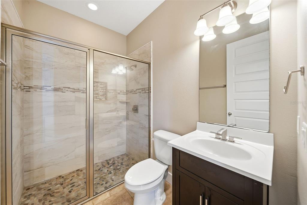 4604 North Fort Christmas Road Christmas, FL 32820 - Photo 12 of 41 a bathroom with a sink toilet a mirror and shower