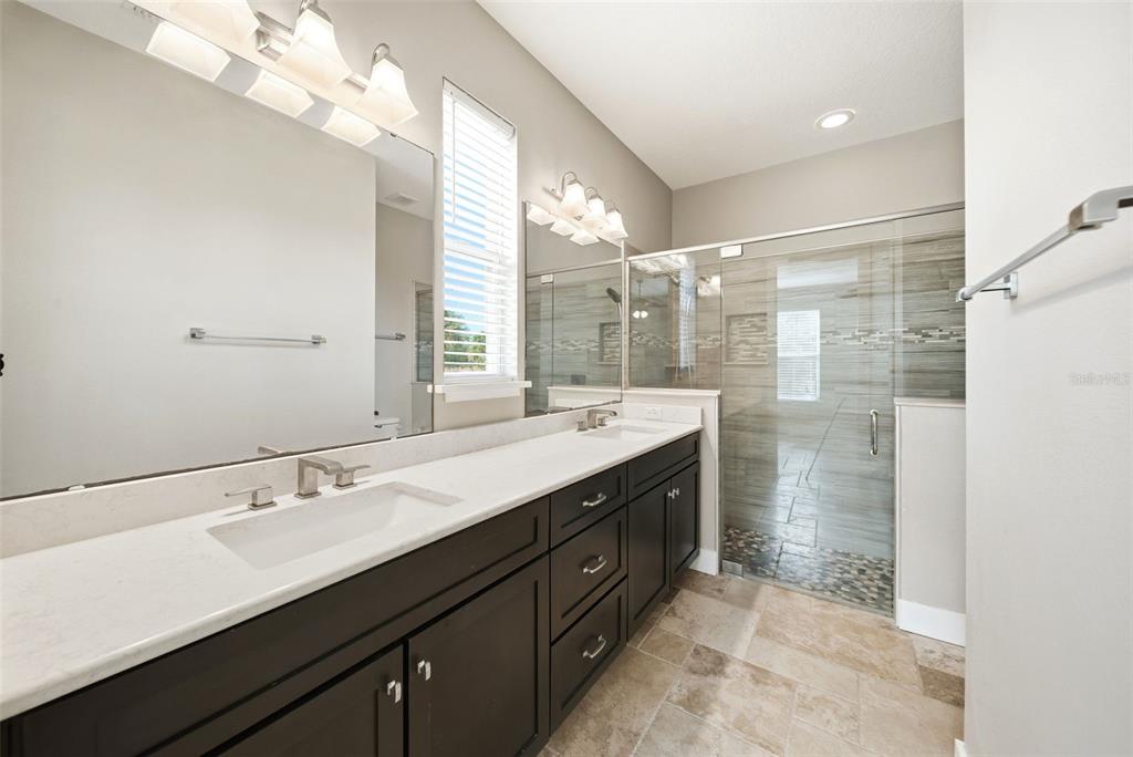 4604 North Fort Christmas Road Christmas, FL 32820 - Photo 23 of 41 a bathroom with a double vanity sink mirror and shower