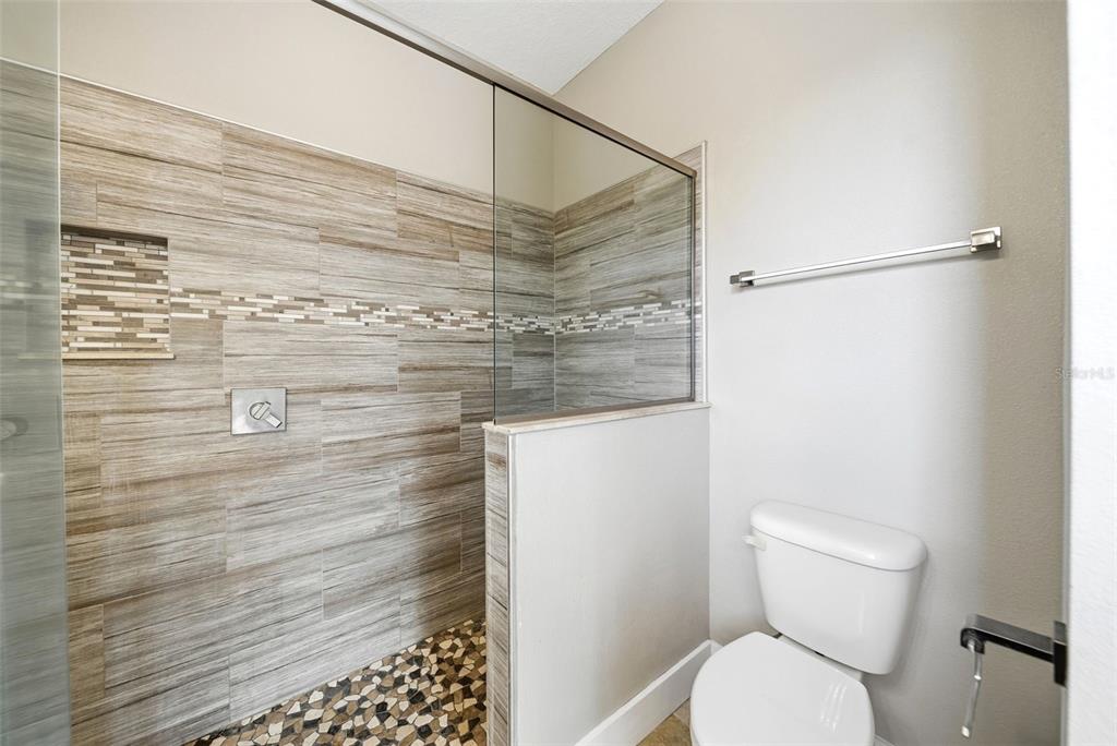 4604 North Fort Christmas Road Christmas, FL 32820 - Photo 24 of 41 a bathroom with a toilet and a shower