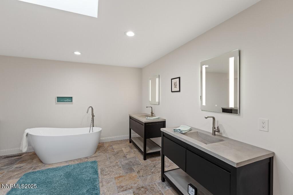 4811 Lakeridge Terrace West Reno, NV 89509 - Photo 29 of 43 a spacious bathroom with a double vanity sink and a bathtub