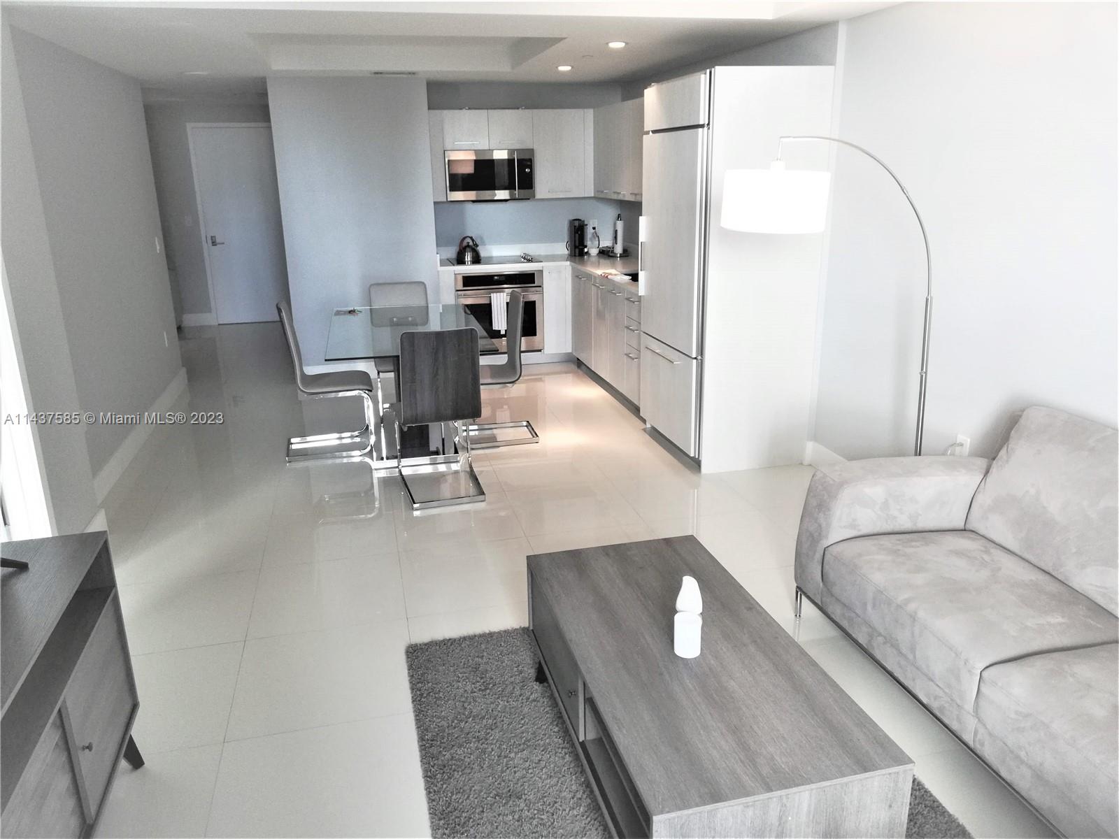 45 Southwest 9th Street, Unit 4004 Miami, FL 33130 - Photo 14 of 23 a living room with stainless steel appliances furniture a rug and a view of kitchen