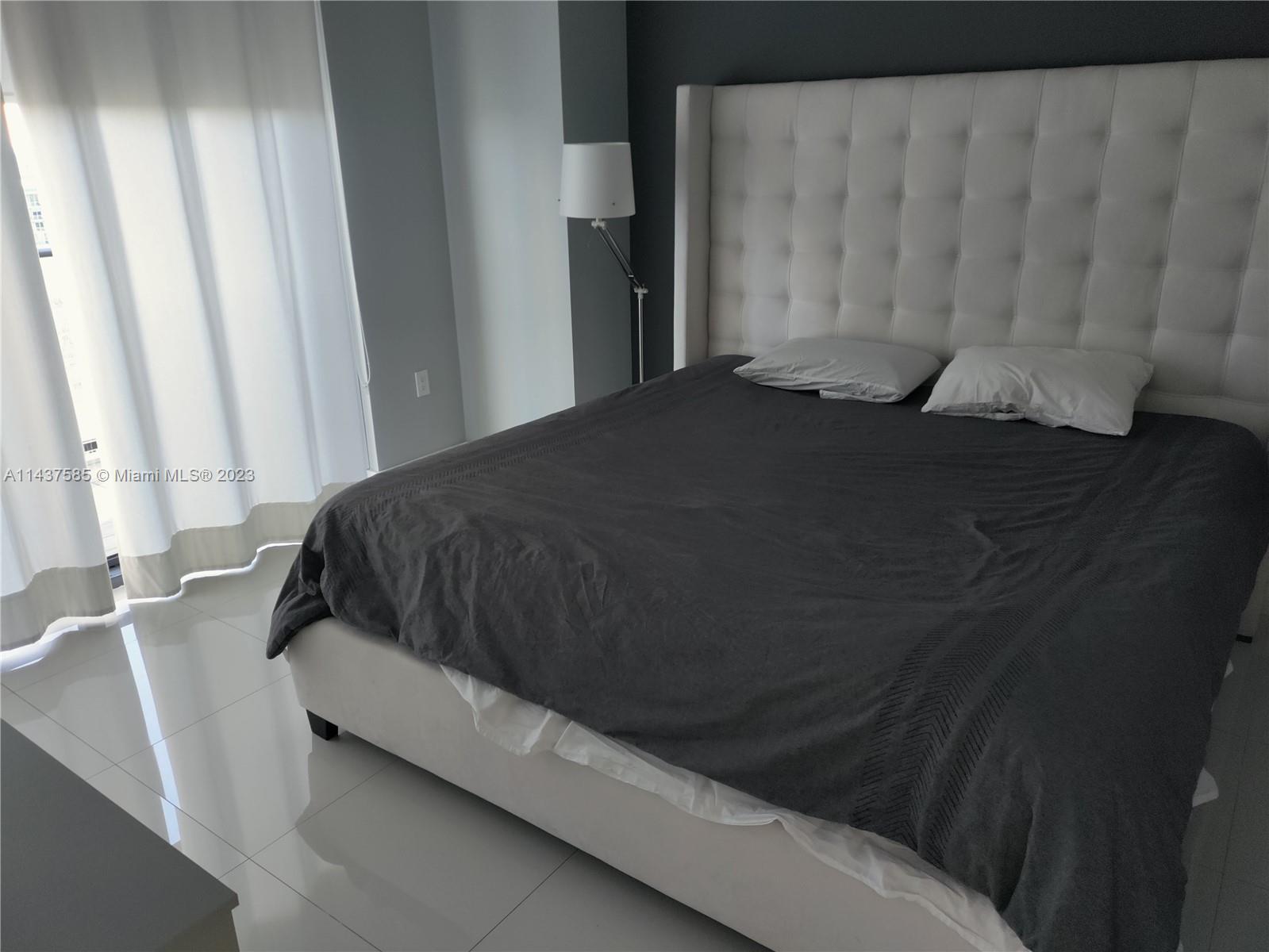 45 Southwest 9th Street, Unit 4004 Miami, FL 33130 - Photo 18 of 23 a bedroom with a bed and a window
