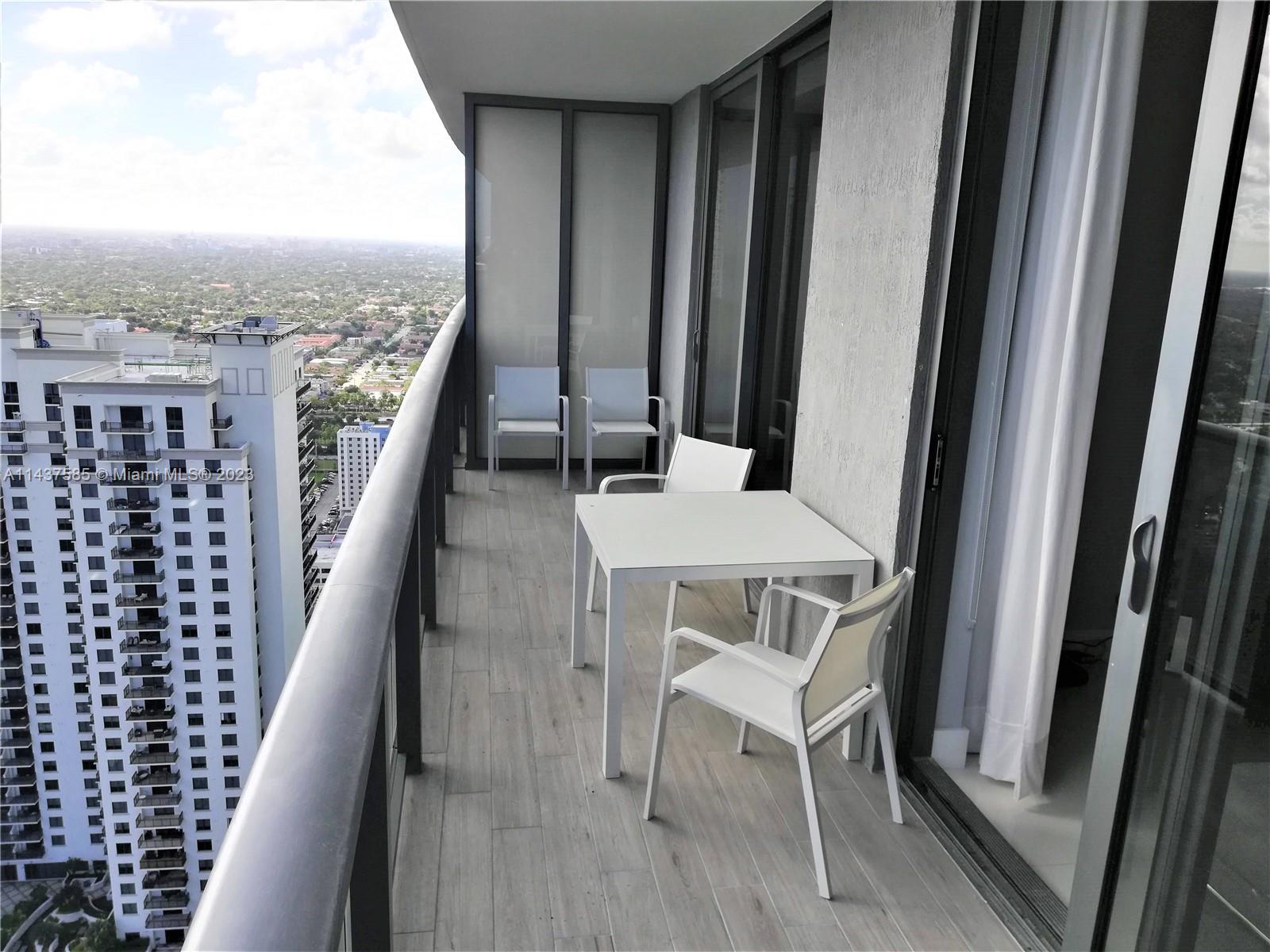 45 Southwest 9th Street, Unit 4004 Miami, FL 33130 - Photo 9 of 23 a dining room with furniture and wooden floor