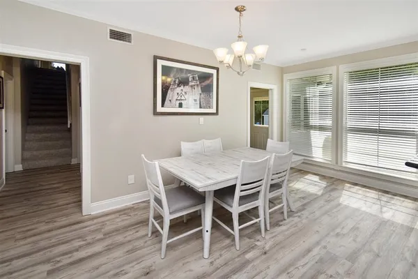a view of a dining room with furniture wooden floor and chandelier