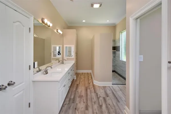 a bathroom with a double vanity sink and mirror