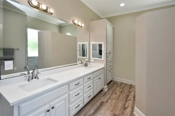 a bathroom with a double vanity sink and a mirror