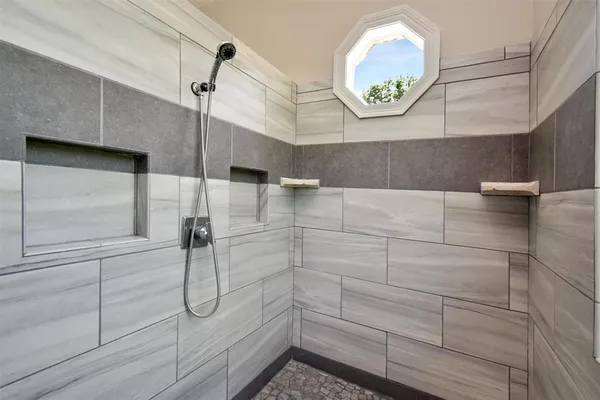 a bathroom with a shower and a window