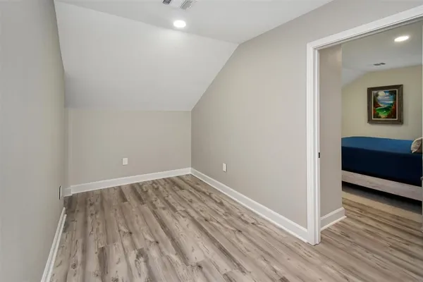 a view of a room with wooden floor