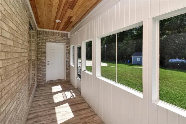 a view of a porch with wooden floor and fence