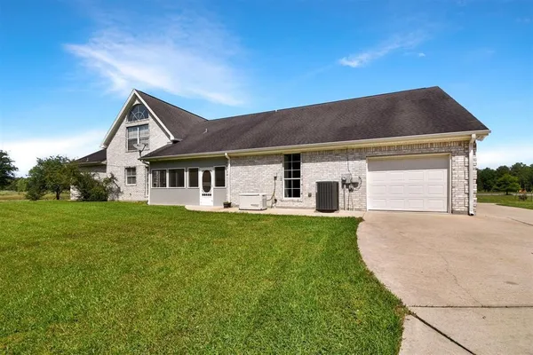 a front view of house with yard and green space