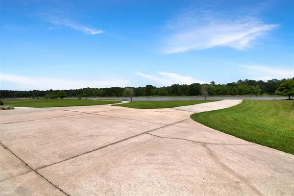 a view of outdoor space with green field and trees