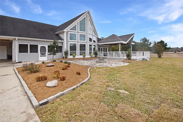 a view of a house with swimming pool and sitting area