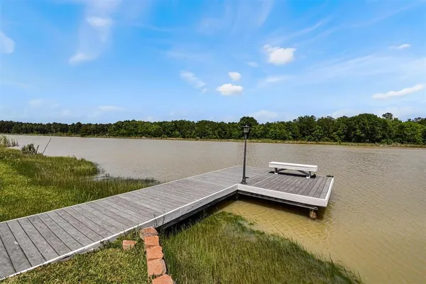 a view of a lake with houses in the background