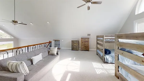 a bedroom with furniture and a ceiling fan