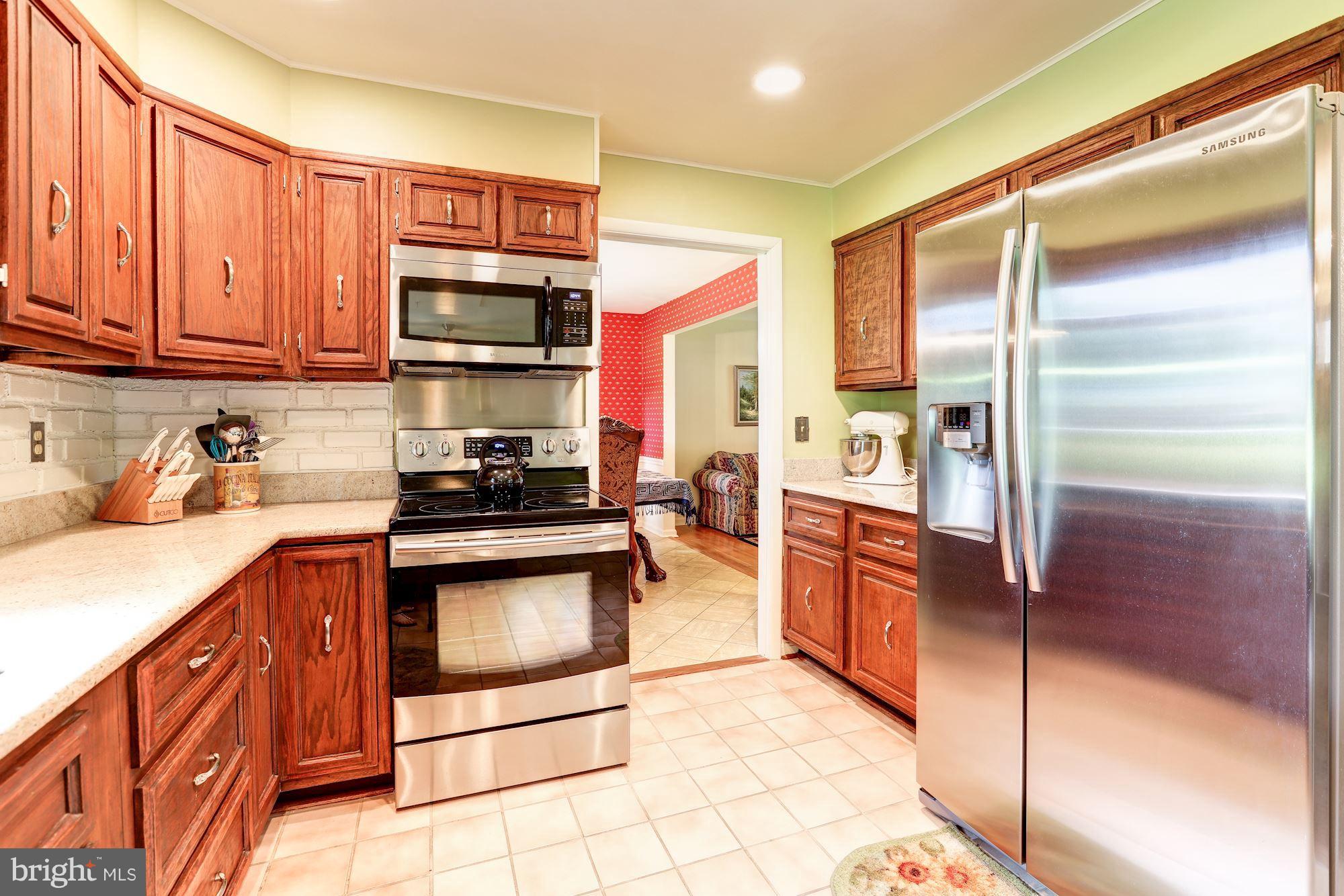 15141 Middlegate Road Silver Spring, MD 20905 - Photo 6 of 30 Kitchen with Stainless Appliances and Granite