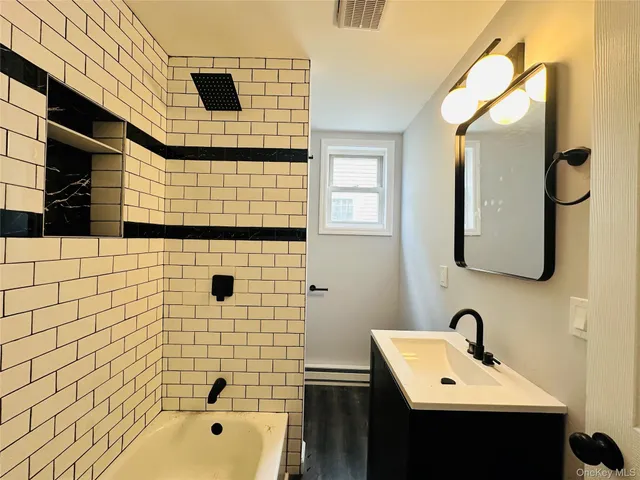 a bathroom with a sink a mirror and shower