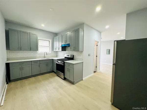 a kitchen with a cabinets and a refrigerator