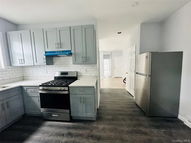 a kitchen with a stove a refrigerator and a sink