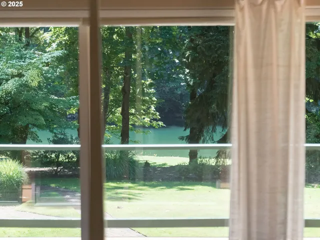 a view of house with backyard and sitting area