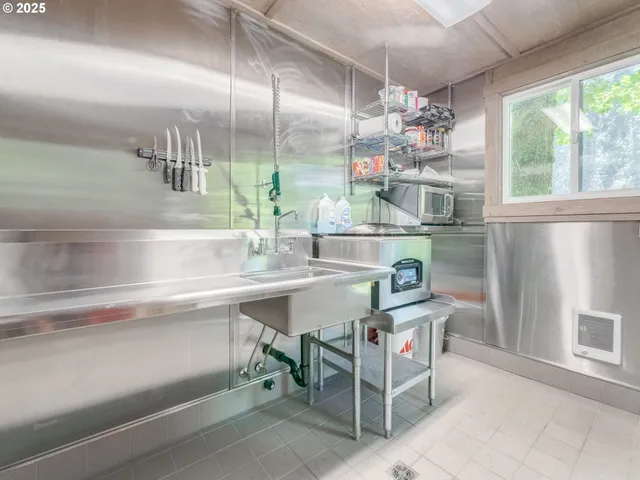 a view of a bathroom with a shower and a window