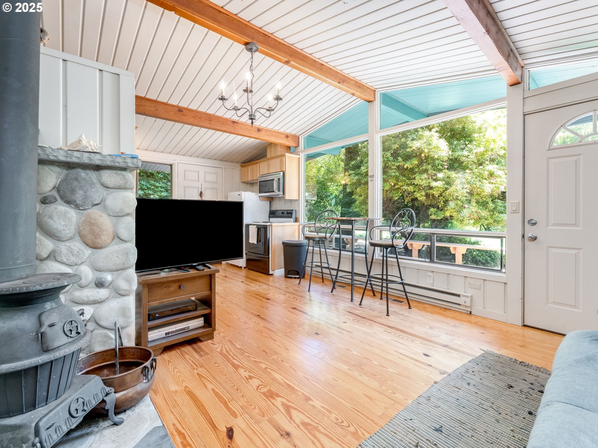3817 Old Lewis River Road Woodland, WA 98674 - Photo 47 of 48 a living room with furniture a flat screen tv and floor to ceiling window