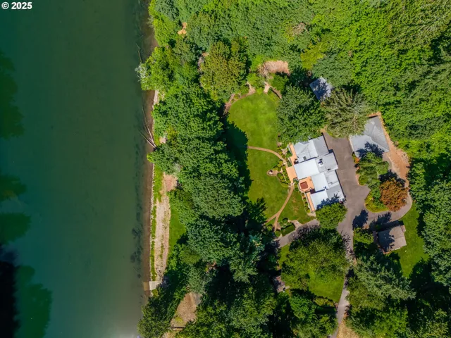 an aerial view of a house with a big yard