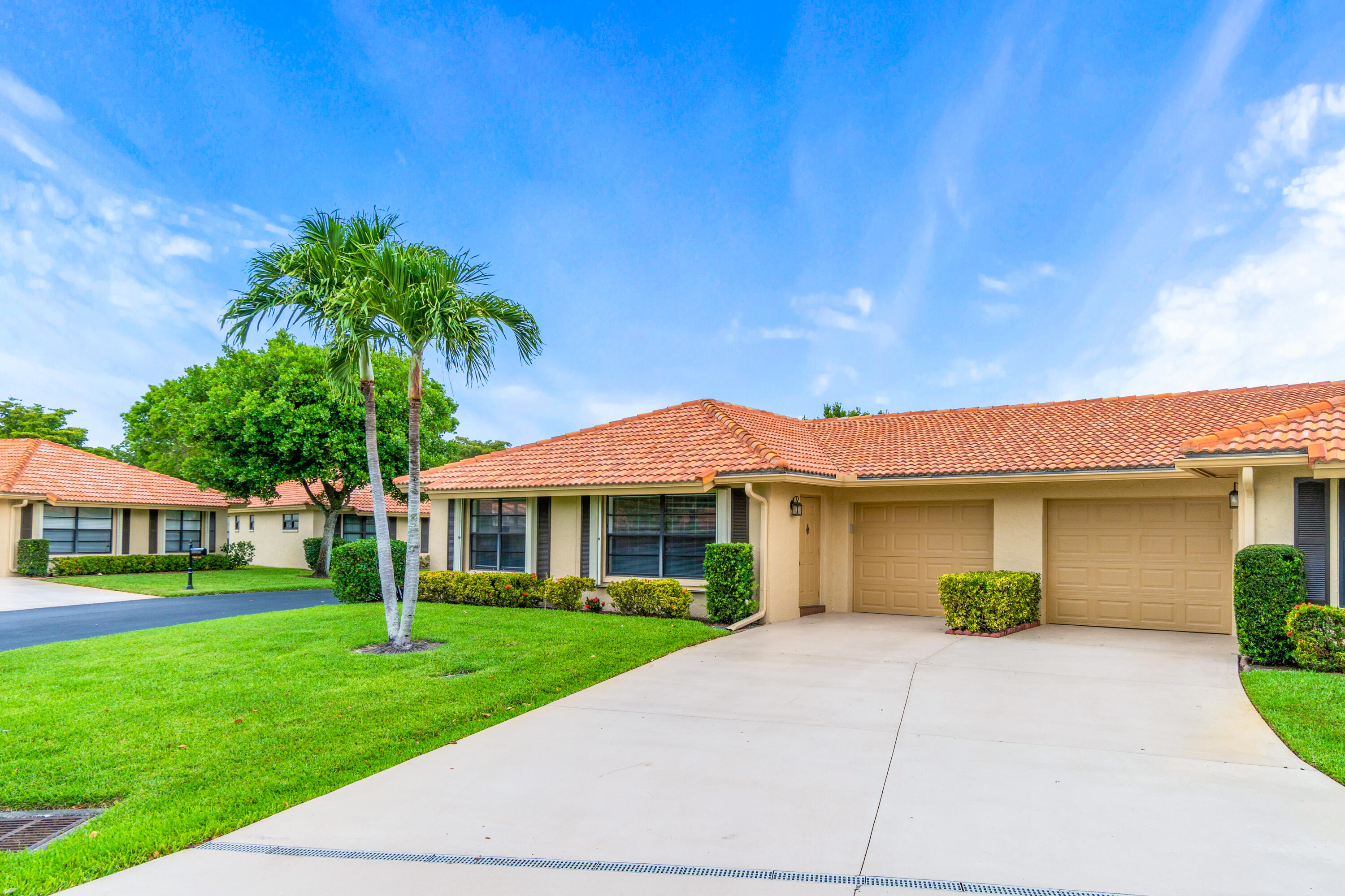 4635 Apple Tree Circle, Unit A Boynton Beach, FL 33436 - Photo 1 of 34 a front view of a house with a yard