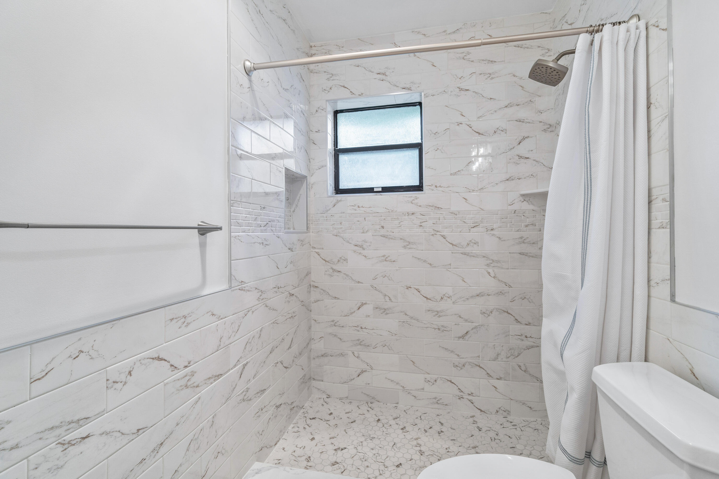 4635 Apple Tree Circle, Unit A Boynton Beach, FL 33436 - Photo 15 of 34 a bathroom with a shower toilet and sink