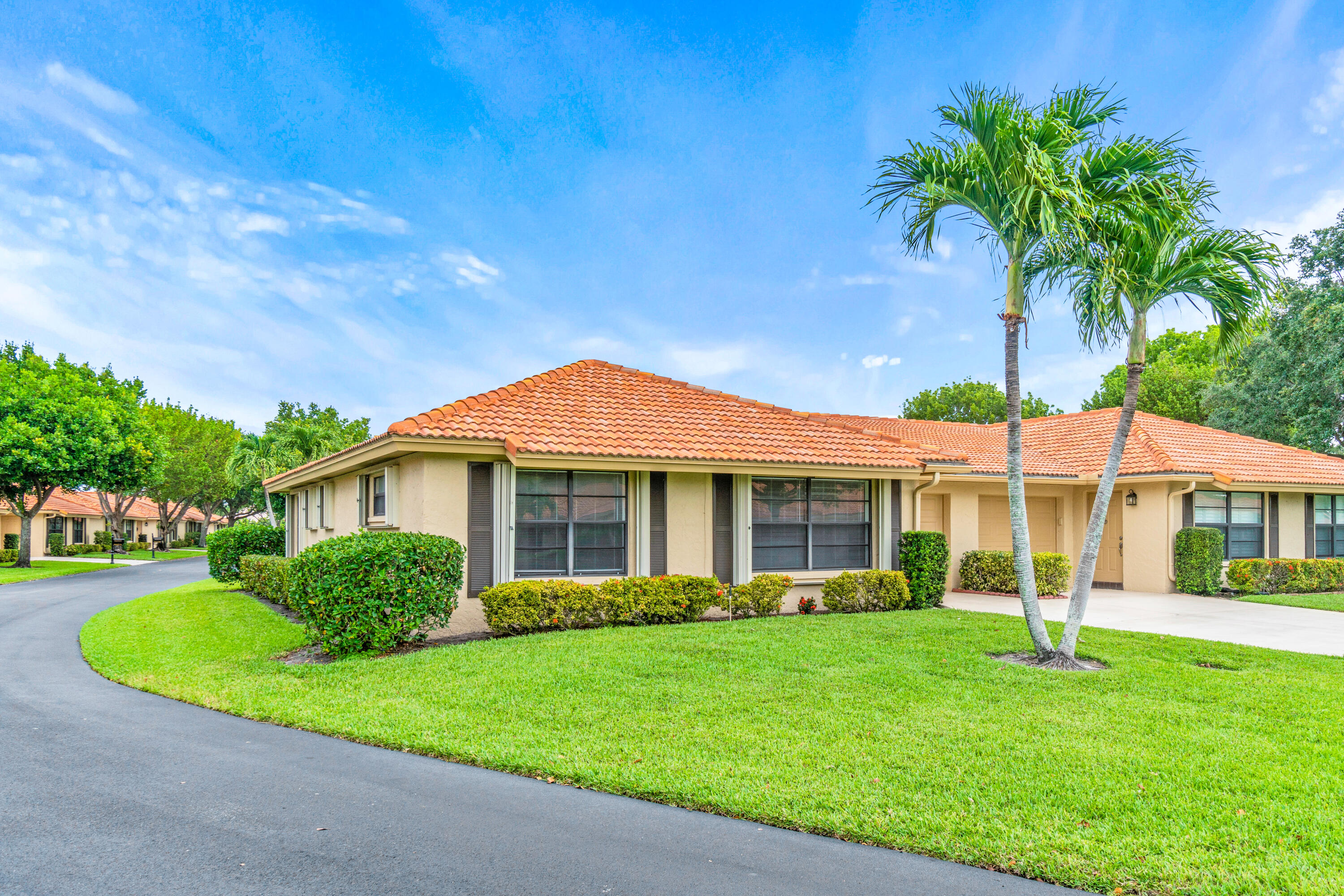 4635 Apple Tree Circle, Unit A Boynton Beach, FL 33436 - Photo 28 of 34 a front view of a house with a yard and porch