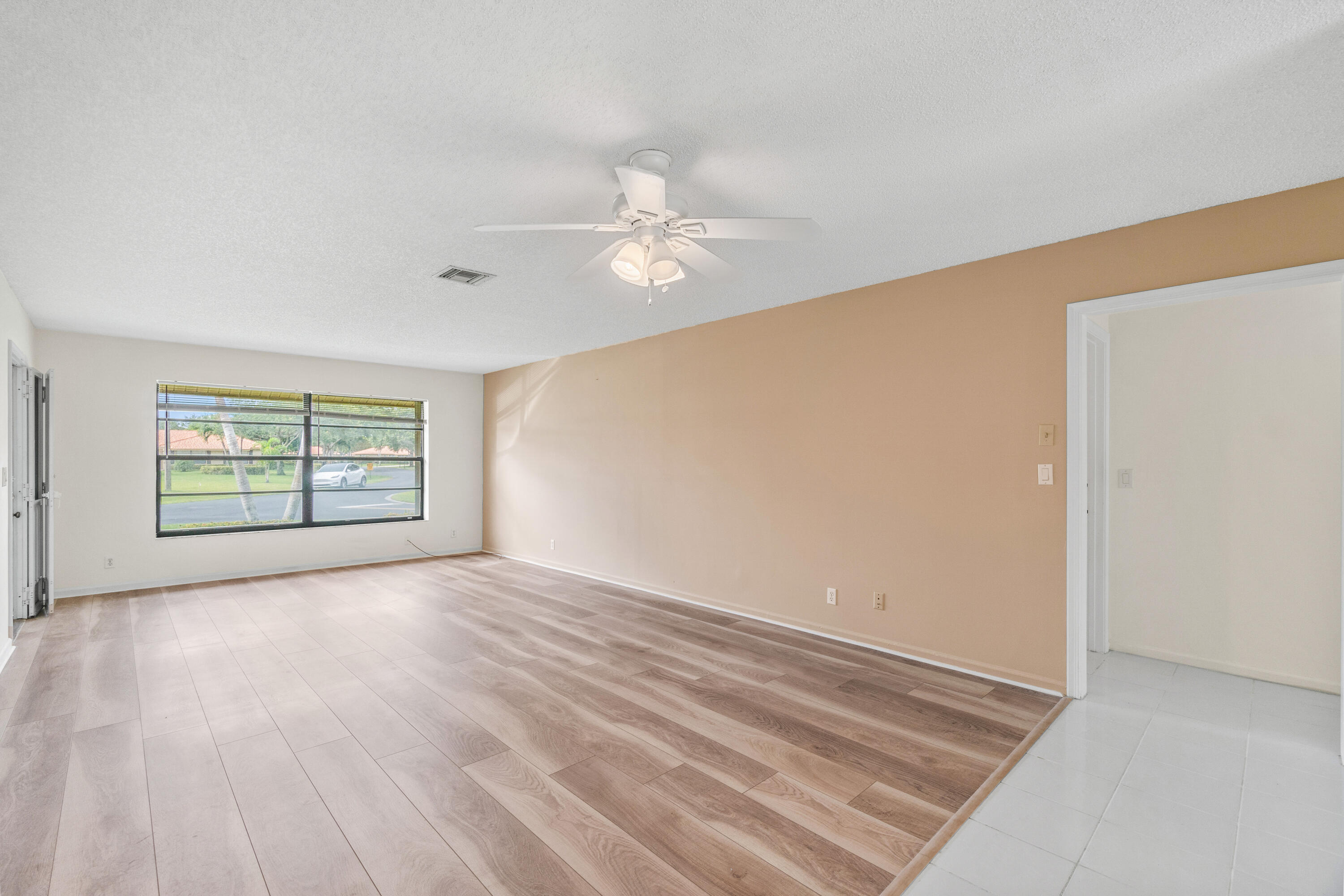 4635 Apple Tree Circle, Unit A Boynton Beach, FL 33436 - Photo 7 of 34 wooden floor in an empty room with a window