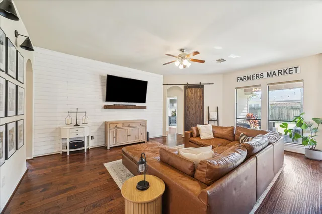 a living room with furniture fireplace and flat screen tv