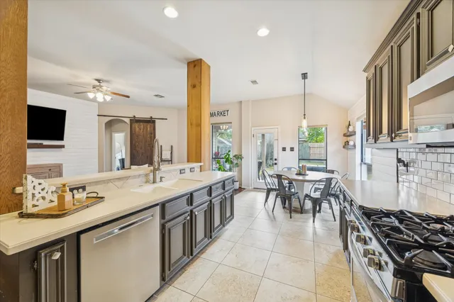 a bedroom with a bed a window and flat screen tv