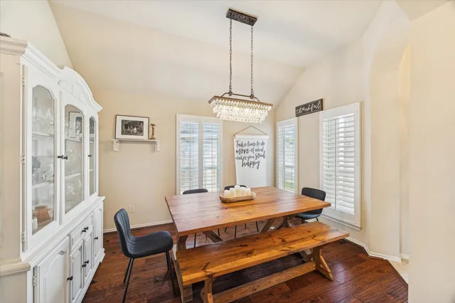 a dining room with furniture and wooden floor
