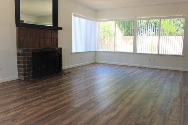 1909 Bardet Place Simi Valley, CA 93065 - Photo 3 of 22 a view of an empty room with wooden floor and a window