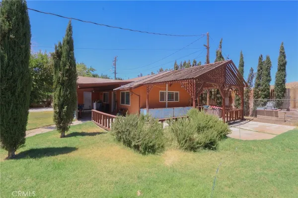 a view of a house with backyard porch and sitting area
