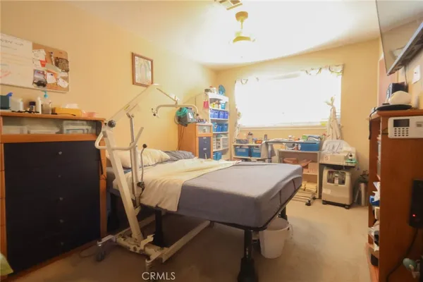 a bedroom with a bed and large windows