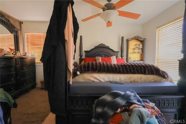 a bedroom with a bed and a painting on the wall