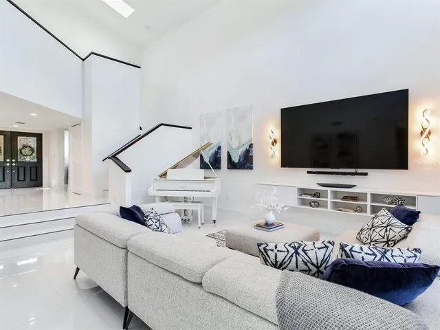 a living room with furniture and a potted plant