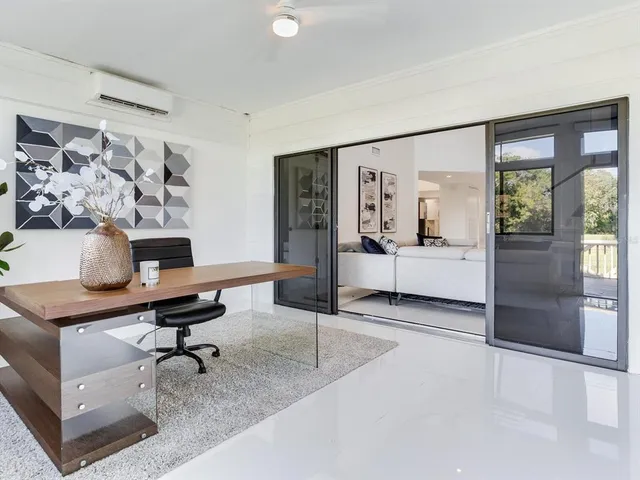 a bedroom with a large bed and a large window