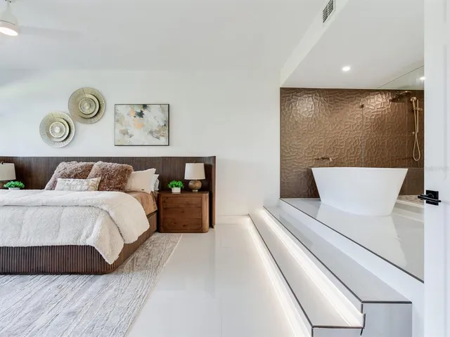 a large white kitchen with wooden floor