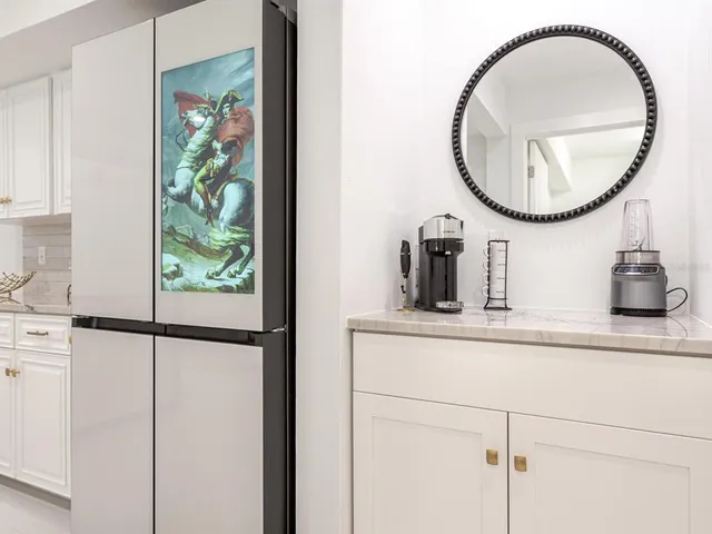 a view of a workspace with furniture and a flat tv screen