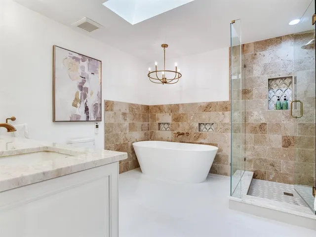 a aerial view of a house with swimming pool and a yard