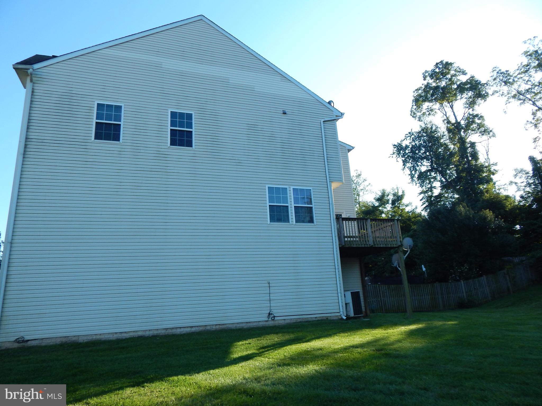 124 Raphael Court Martinsburg, WV 25403 - Photo 26 of 30 a view of a backyard with potted plants and large tree