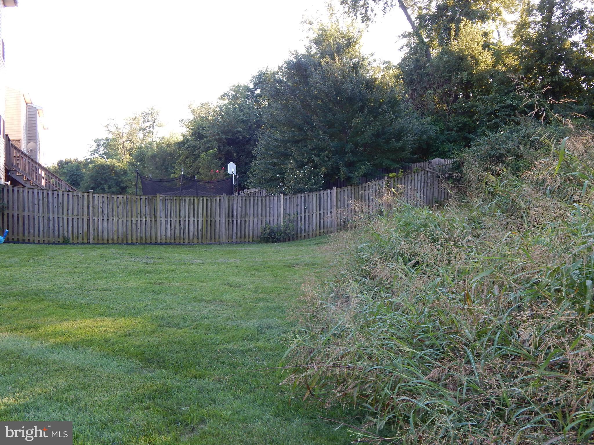 124 Raphael Court Martinsburg, WV 25403 - Photo 29 of 30 a view of a backyard with potted plants and wooden fence