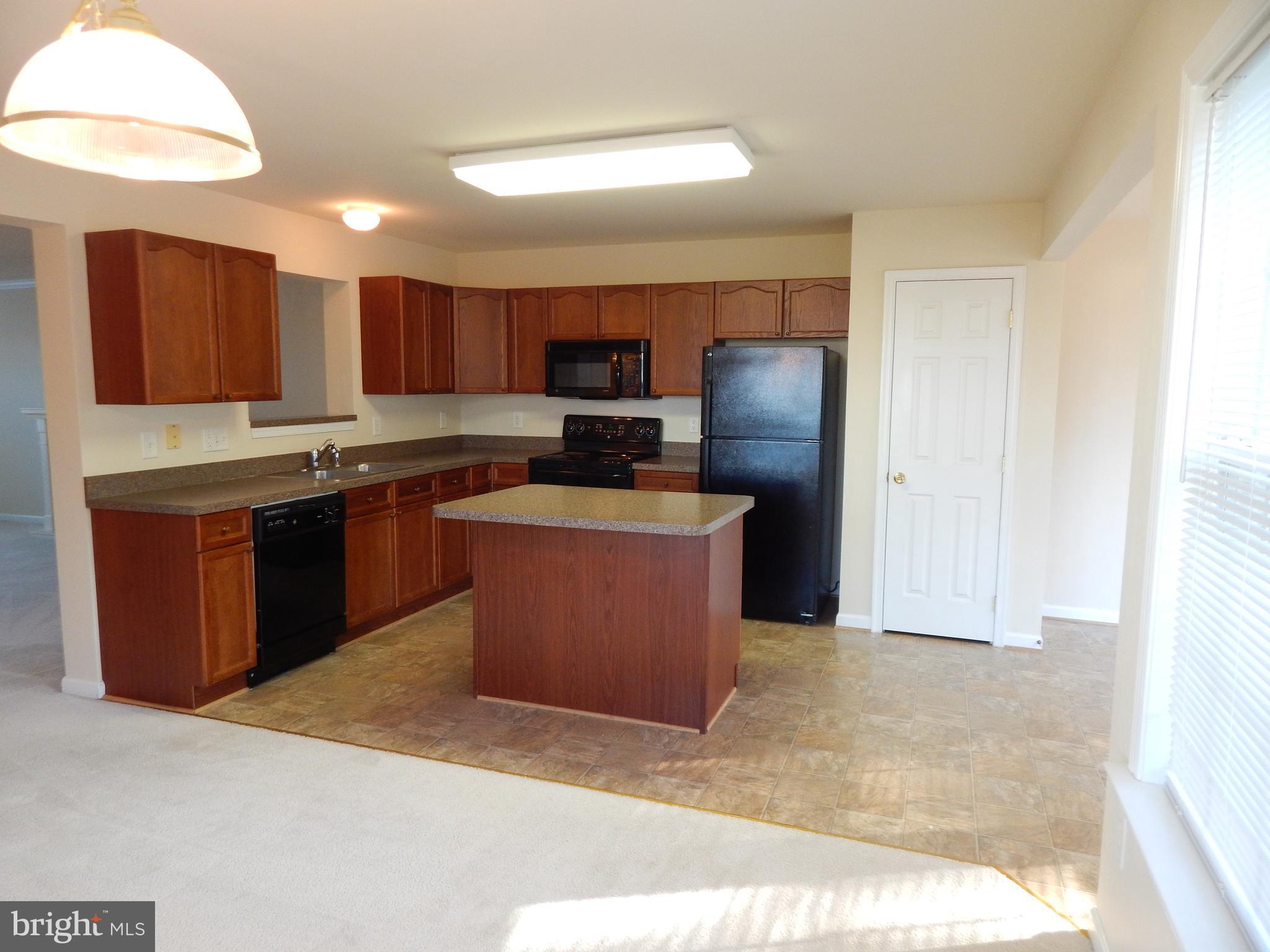 124 Raphael Court Martinsburg, WV 25403 - Photo 8 of 30 a kitchen with stainless steel appliances granite countertop a stove top oven a sink and a refrigerator